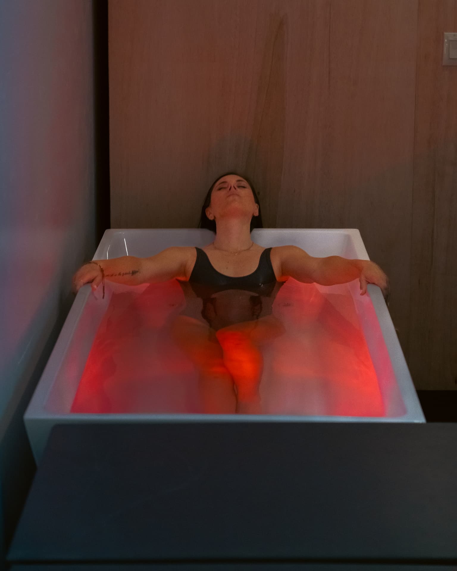 Member relaxing in a cold plunge tub at API's Recovery Zone in Hailey, ID