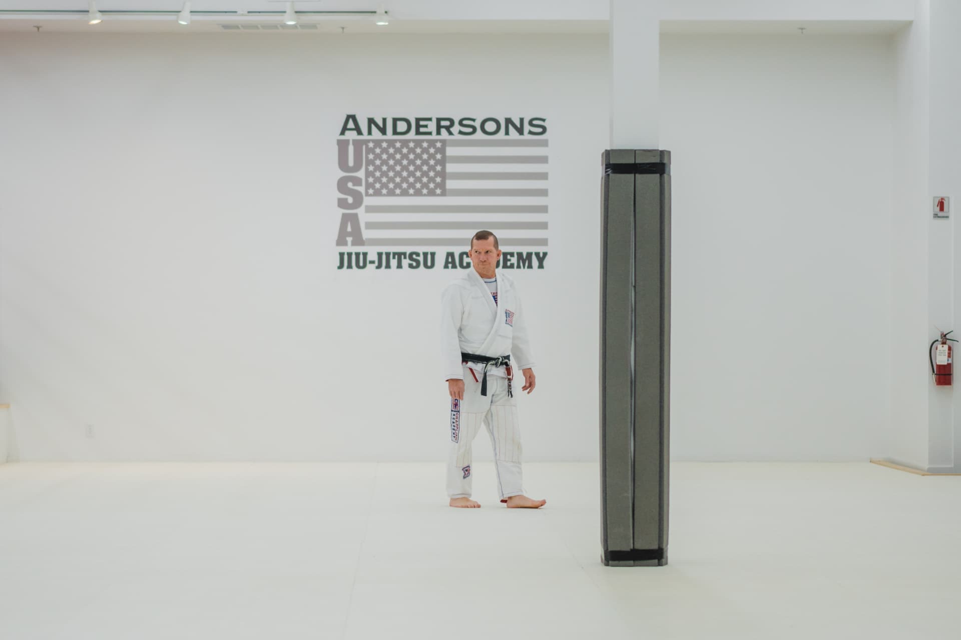 Lee Anderson, founder and head coach at API, in his white gi with black belt at Anderson's USA Jiu-Jitsu Academy